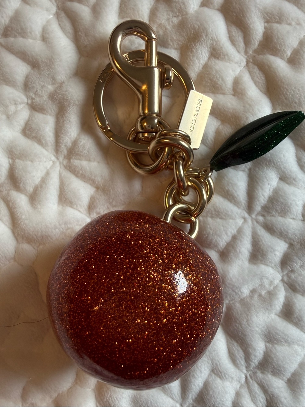 Coach Sparkling Orange Keychain with Green Leaf Charm
